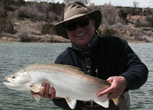 fly fisherman holding giant tiger trout