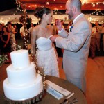 Groom feeding bride wedding cake